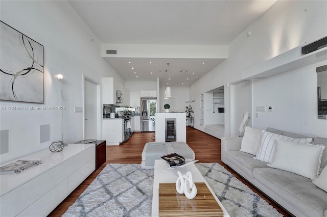 living room featuring dark hardwood / wood-style floors and wine cooler