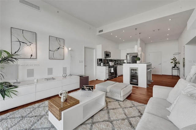 living room featuring wine cooler and light wood-type flooring