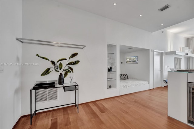 hallway with hardwood / wood-style floors