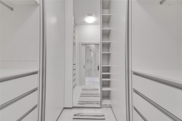 spacious closet featuring light tile patterned floors