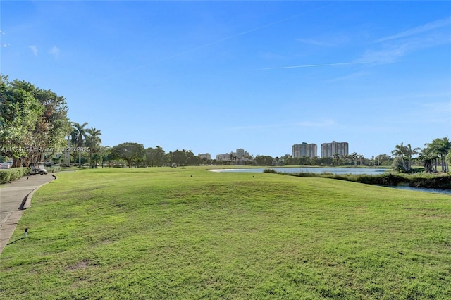 view of community featuring a water view and a yard