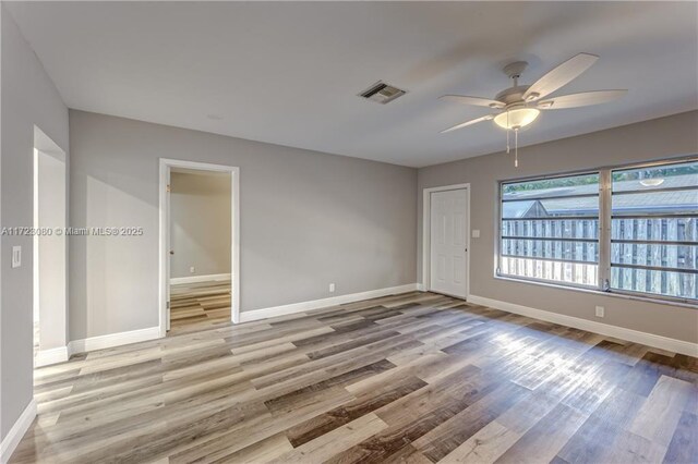 unfurnished room with ceiling fan and light hardwood / wood-style flooring