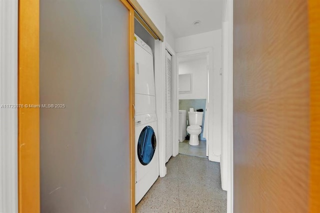 laundry room featuring stacked washer and dryer