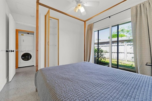 bedroom featuring ceiling fan and stacked washer and dryer