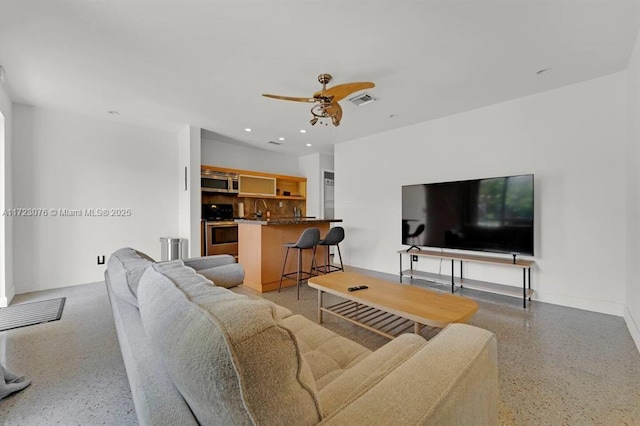 living room with ceiling fan and sink