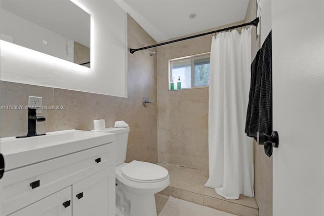 bathroom featuring toilet, vanity, tile patterned flooring, and curtained shower