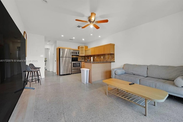 living room with ceiling fan and sink