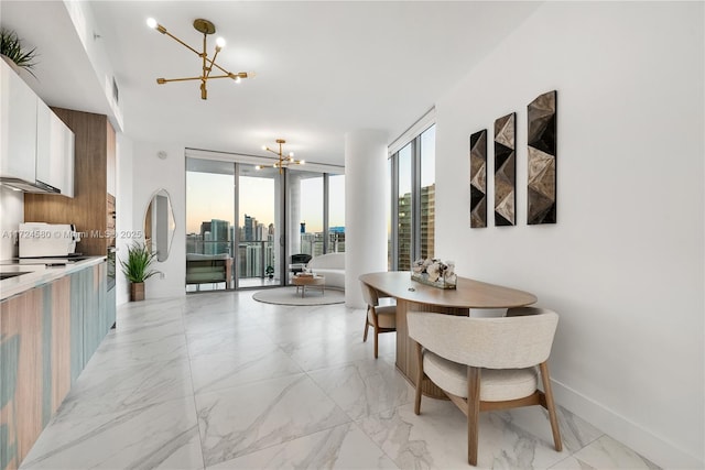 dining room featuring expansive windows and a chandelier