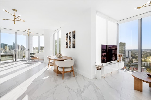 2900 NE 7th Ave Unit 3509, Miami, FL 33137 - living room featuring a chandelier, a wall of windows, a skyline view, baseboards, and marble finish flooring