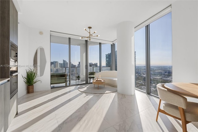 2900 NE 7th Ave Unit 3509, Miami, FL 33137 - interior space featuring a view of skyline, floor to ceiling windows, a chandelier, access to outside, and light marble finish floors