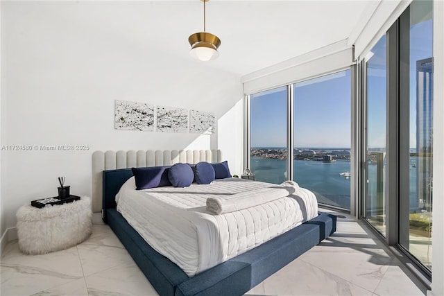 bedroom featuring a water view and vaulted ceiling