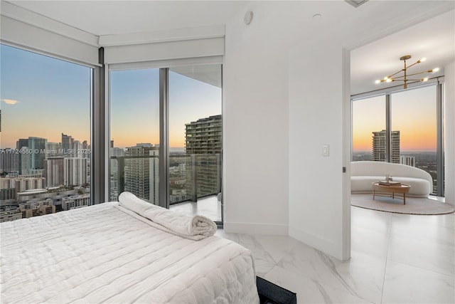 bedroom with access to outside, multiple windows, and a notable chandelier