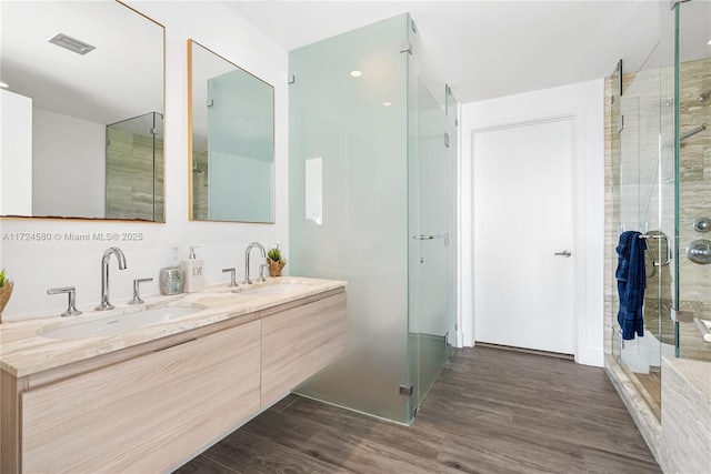 bathroom with vanity, hardwood / wood-style flooring, and an enclosed shower