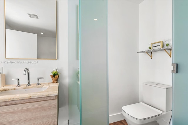 bathroom with vanity and toilet