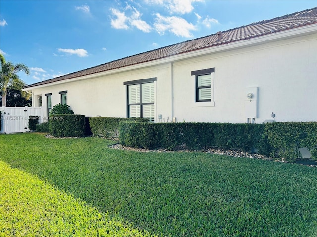 view of side of home featuring a lawn