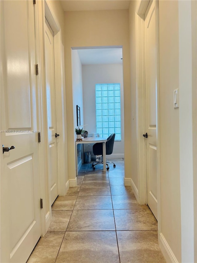 corridor with light tile patterned floors