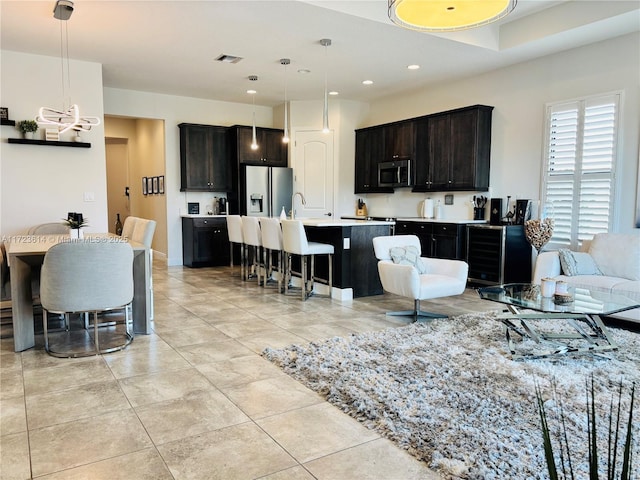 living room featuring sink and light tile patterned floors