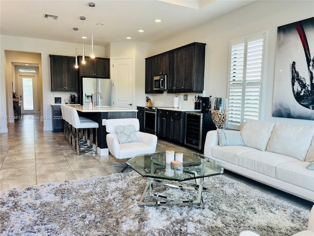 living room with wine cooler and light tile patterned floors