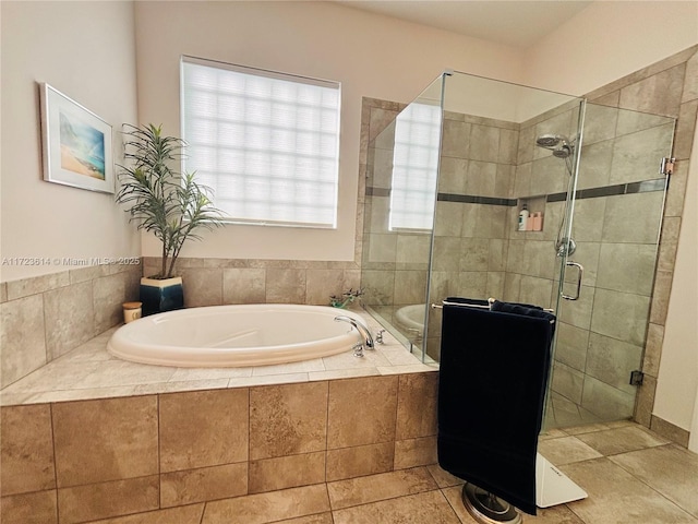 bathroom featuring tile patterned flooring and shower with separate bathtub