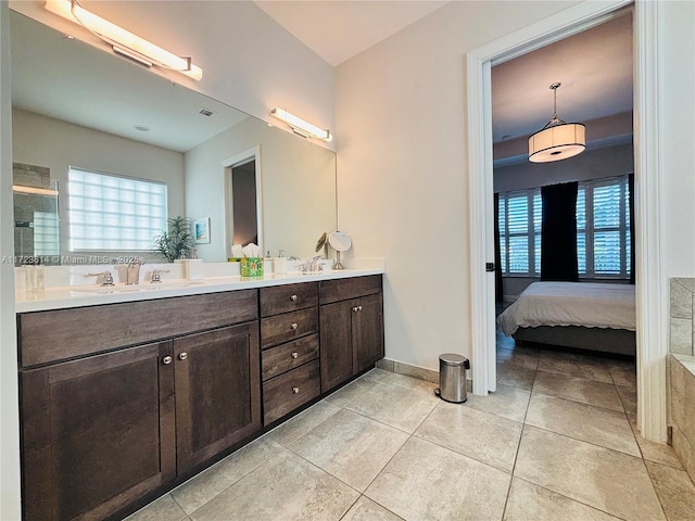 bathroom with tile patterned floors, a wealth of natural light, vanity, and a shower with shower door