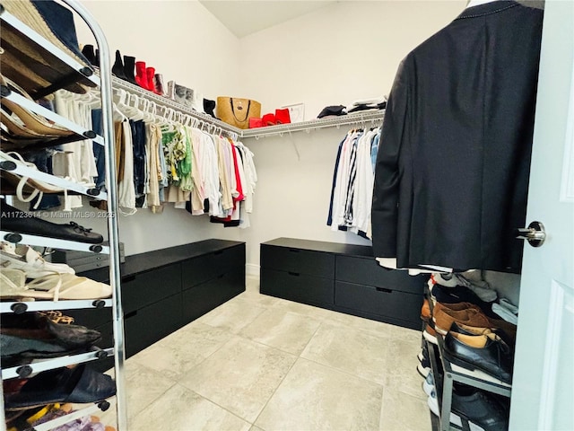 spacious closet featuring light tile patterned floors