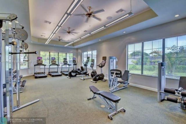 gym with ceiling fan and a healthy amount of sunlight