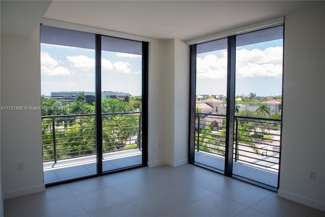 spare room featuring floor to ceiling windows and a healthy amount of sunlight