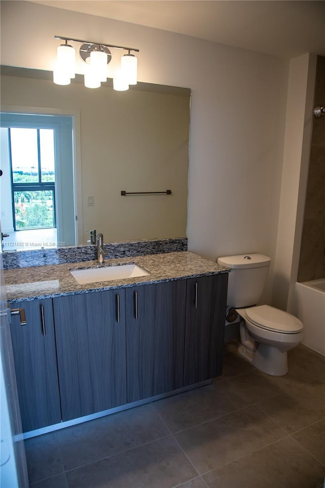 bathroom with tile patterned floors, vanity, and toilet