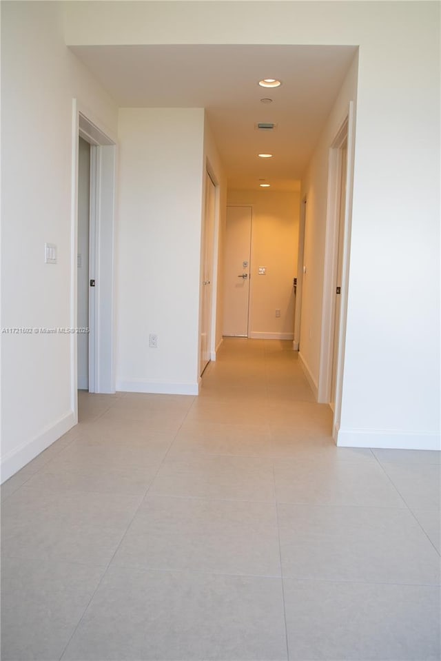 hall with light tile patterned floors