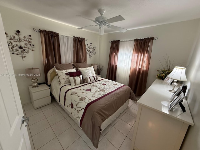 bedroom with ceiling fan and light tile patterned flooring