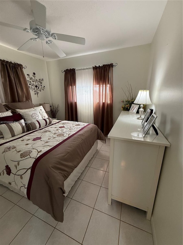 tiled bedroom with ceiling fan