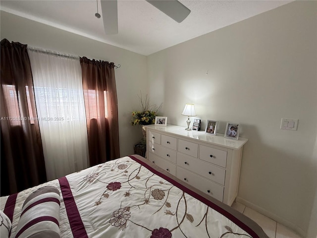 bedroom with ceiling fan and light tile patterned floors