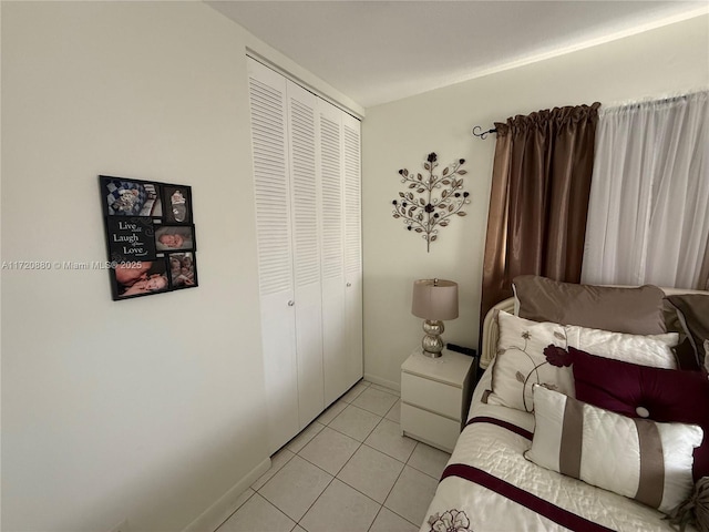 bedroom featuring light tile patterned floors and a closet