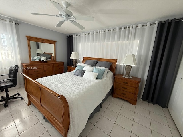 bedroom with ceiling fan and light tile patterned floors