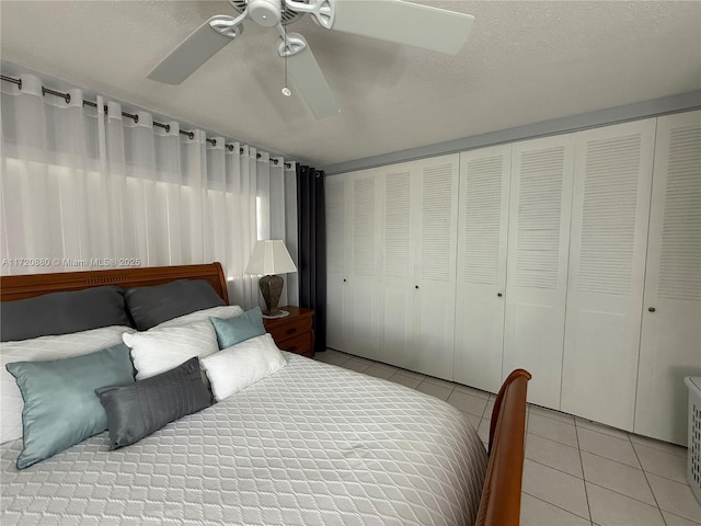 tiled bedroom featuring a textured ceiling, a closet, and ceiling fan