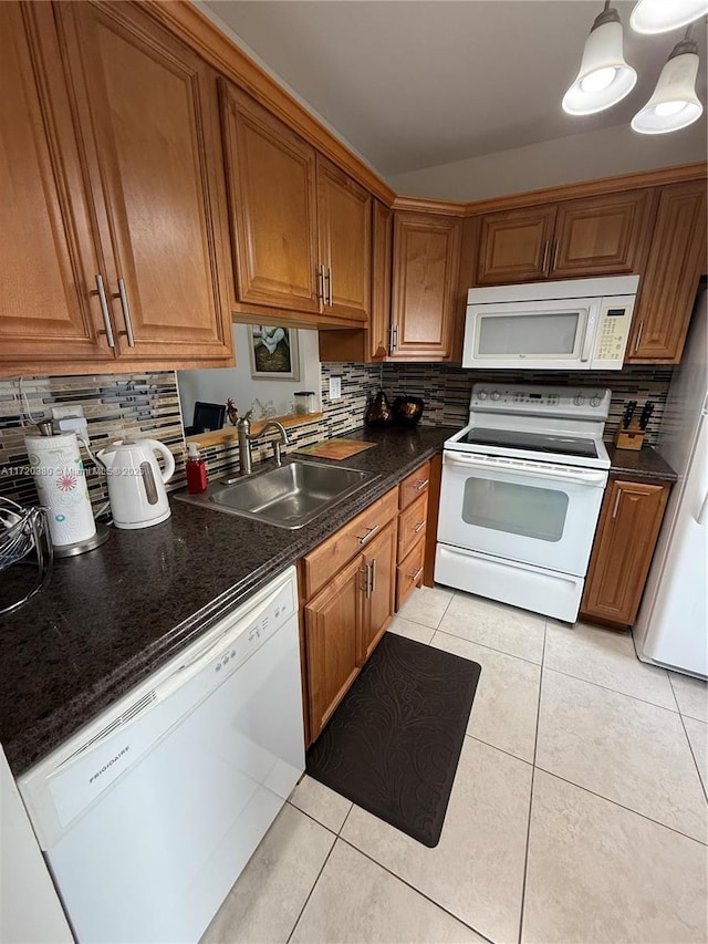 kitchen featuring decorative backsplash, white appliances, sink, and light tile patterned floors