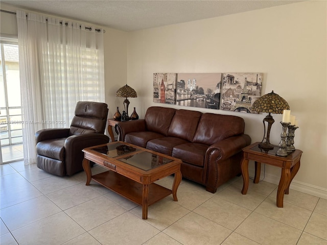 living room featuring light tile patterned floors and a textured ceiling