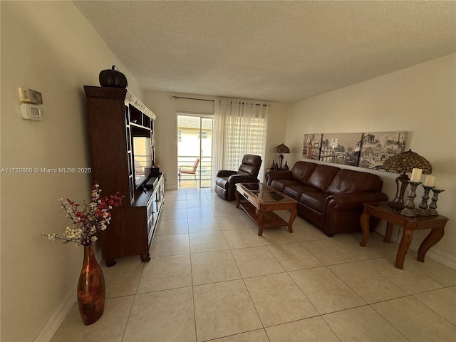 living room featuring light tile patterned floors and a textured ceiling