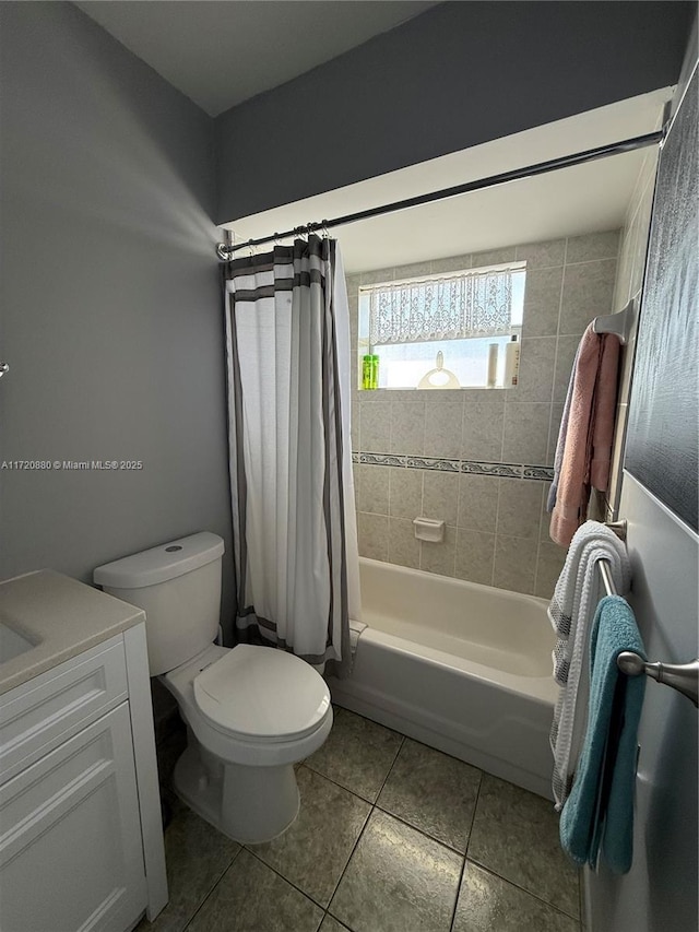 full bathroom with tile patterned floors, vanity, shower / tub combo, and toilet