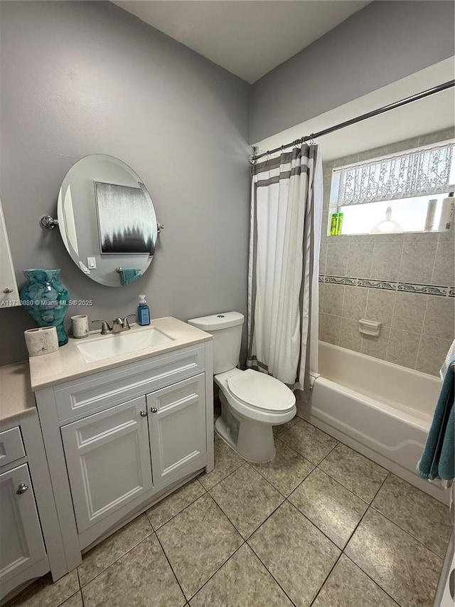 full bathroom with tile patterned floors, vanity, shower / bathtub combination with curtain, and toilet