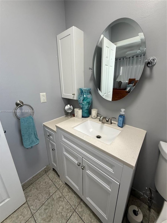 bathroom with tile patterned floors, vanity, and toilet