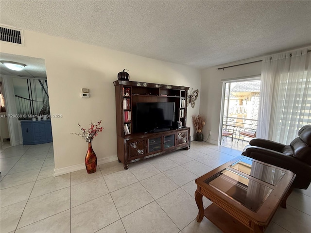 living room featuring light tile patterned floors and a textured ceiling