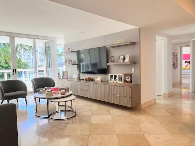 living room featuring a wall of windows and french doors