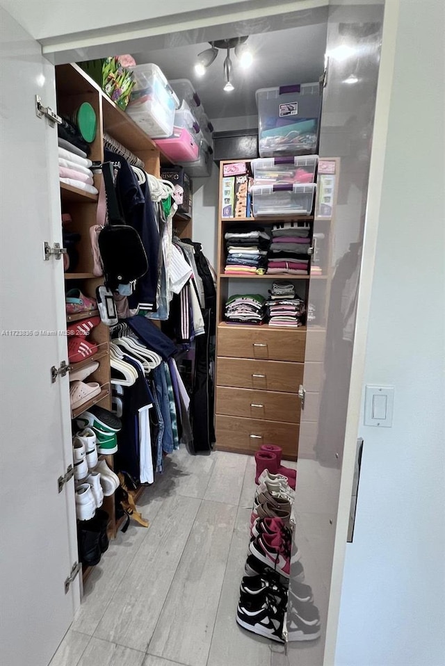 spacious closet featuring light wood-type flooring