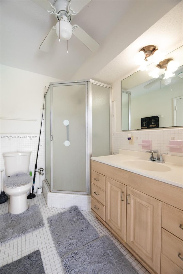 bathroom featuring a ceiling fan, tile patterned flooring, vanity, and a shower stall