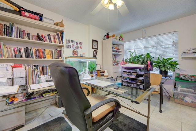 office area featuring a textured ceiling, tile patterned flooring, and a ceiling fan