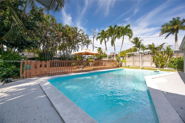 view of pool featuring fence, a fenced in pool, and a patio