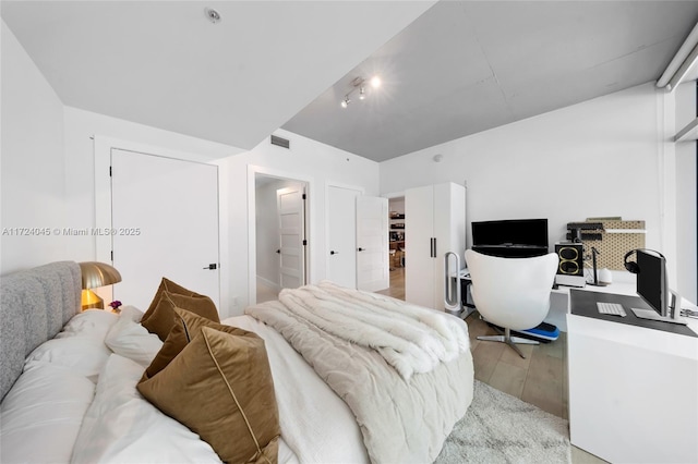 bedroom featuring light wood-type flooring and a closet