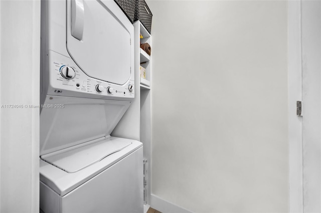 clothes washing area with stacked washer and clothes dryer