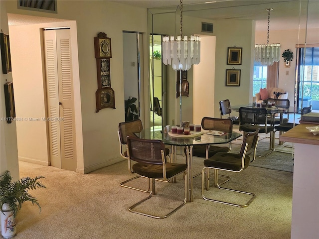 carpeted dining area featuring a notable chandelier